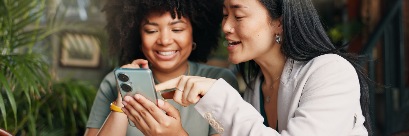 Two women looking at a smartphone