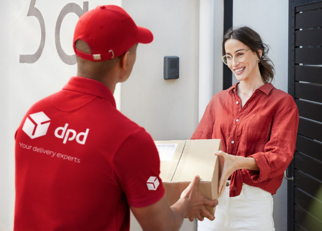 Woman receiving a parcel from their dpd driver