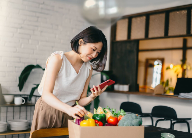 Woman unboxing fresh goods