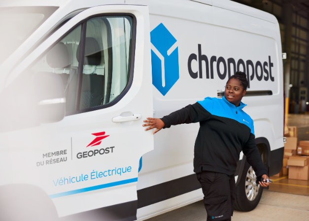 Chronopost driver in front of her electric van